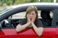 Female rookie new driver young beautiful woman scared and stressed while driving car in fear and shock