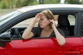 Female rookie new driver young beautiful woman scared and stressed while driving car in fear and shock