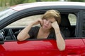 Female rookie new driver young beautiful woman scared and stressed while driving car in fear and shock