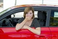 Female rookie new driver young beautiful woman scared and stressed while driving car in fear and shock