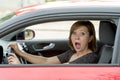 Female rookie new driver young beautiful woman scared and stressed while driving car in fear and shock