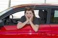 Female rookie new driver young beautiful woman scared and stressed while driving car in fear and shock