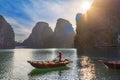 Female rower at Bai Tu Long Bay waiting for tourists, Vietnam