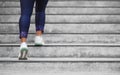 Female runner athlete doing a stairs climbing. Running woman doing run up steps on staircase in urban city. Doing cardio sport Royalty Free Stock Photo