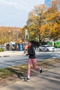 Female runner in a dark sweater on the sidewalk in downtown Washington