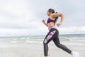 Female runner jogging during outdoor workout on the beach Royalty Free Stock Photo