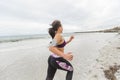 Female runner jogging during outdoor workout on the beach Royalty Free Stock Photo