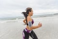 Female runner jogging during outdoor workout on the beach Royalty Free Stock Photo
