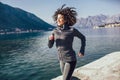 Female runner jogging during outdoor workout on beach Royalty Free Stock Photo