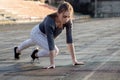 Female runner stretching legs on running track