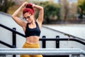 Female runner stretching, preparing for training. Fitness athletic woman warming up for running Royalty Free Stock Photo