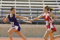 Female Runners In Relay Race Royalty Free Stock Photo