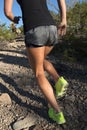 Female running up desert mountain