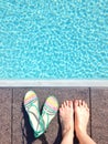 Female`s feet by a swimming pool Royalty Free Stock Photo