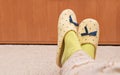 Female`s feet with yellow slippers and green socks Royalty Free Stock Photo