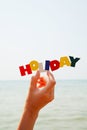 Female's hand holding colorful word 'Holiday'