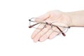 Female`s hand holding glasse on white background. Glasses in han