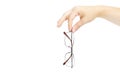 Female`s hand holding glasse on white background. Glasses in han