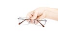 Female`s hand holding glasse on white background. Glasses in han