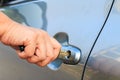 Female's hand opening a car door with car key. Royalty Free Stock Photo