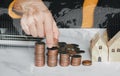 Female`s hand put coin stack money staircase on table with effect halftone graphic blur with World map, Business Growth concept Royalty Free Stock Photo