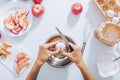 Female`s hands cracking egg into bowl