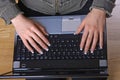 Female's hands on notebook keyboard