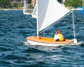 A female sailor Sailing small sailboat solo on an inland waterway