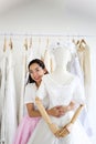 Female sales assistant in bridalwear store wedding dress in a sh Royalty Free Stock Photo
