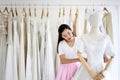 Female sales assistant in bridalwear store wedding dress in a sh Royalty Free Stock Photo