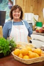 Female Sales Assistant At Checkout Of Farm Shop Royalty Free Stock Photo