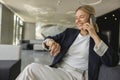 Businesswoman looking at her wristwatch to checking the time while having a phone call with client Royalty Free Stock Photo