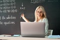 Female school college teacher having online distance virtual class in classroom. Royalty Free Stock Photo