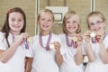 Female School Sports Team In Gym With Medals Royalty Free Stock Photo