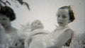 1937: Female schoolmates playing doll outdoor backyard.