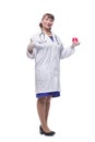 Female scientific researcher in protective gloves holding beaker with red liquid solution at pharmacy microbiology