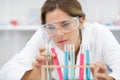 female scientist analysing rack test tubes Royalty Free Stock Photo