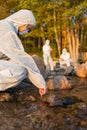 Female scientist collecting water sample from sea with her team Royalty Free Stock Photo