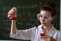 female scientist doing scientific tests with chemical flask and liquid in school laboratory Royalty Free Stock Photo