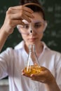 female scientist doing scientific tests with chemical flask and liquid in school laboratory Royalty Free Stock Photo