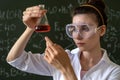 female scientist doing scientific tests with chemical flask and liquid in school laboratory Royalty Free Stock Photo