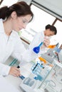 female scientist examining liquid in flask Royalty Free Stock Photo