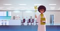 Female scientist examining plant sample in test tube african american woman making experiment chemical research science