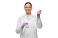 Female scientist in goggles with chemical in flask