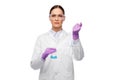 Female scientist in goggles with chemical in flask