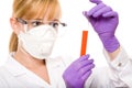 Female scientist in goggles and mask holds tube