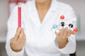 Female scientist holding dna molecule and test tube Royalty Free Stock Photo