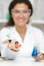 female scientist holding molecules model and glass flask Royalty Free Stock Photo