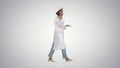Female scientist making a call walking on gradient background. Royalty Free Stock Photo