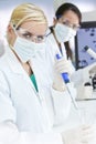 Female Scientist Pipette & Flask In Laboratory Royalty Free Stock Photo